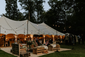 Sailcloth marquee at night with pretty lights and outdoor furniture